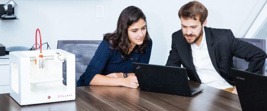 Man and a woman looking at a laptop screen together